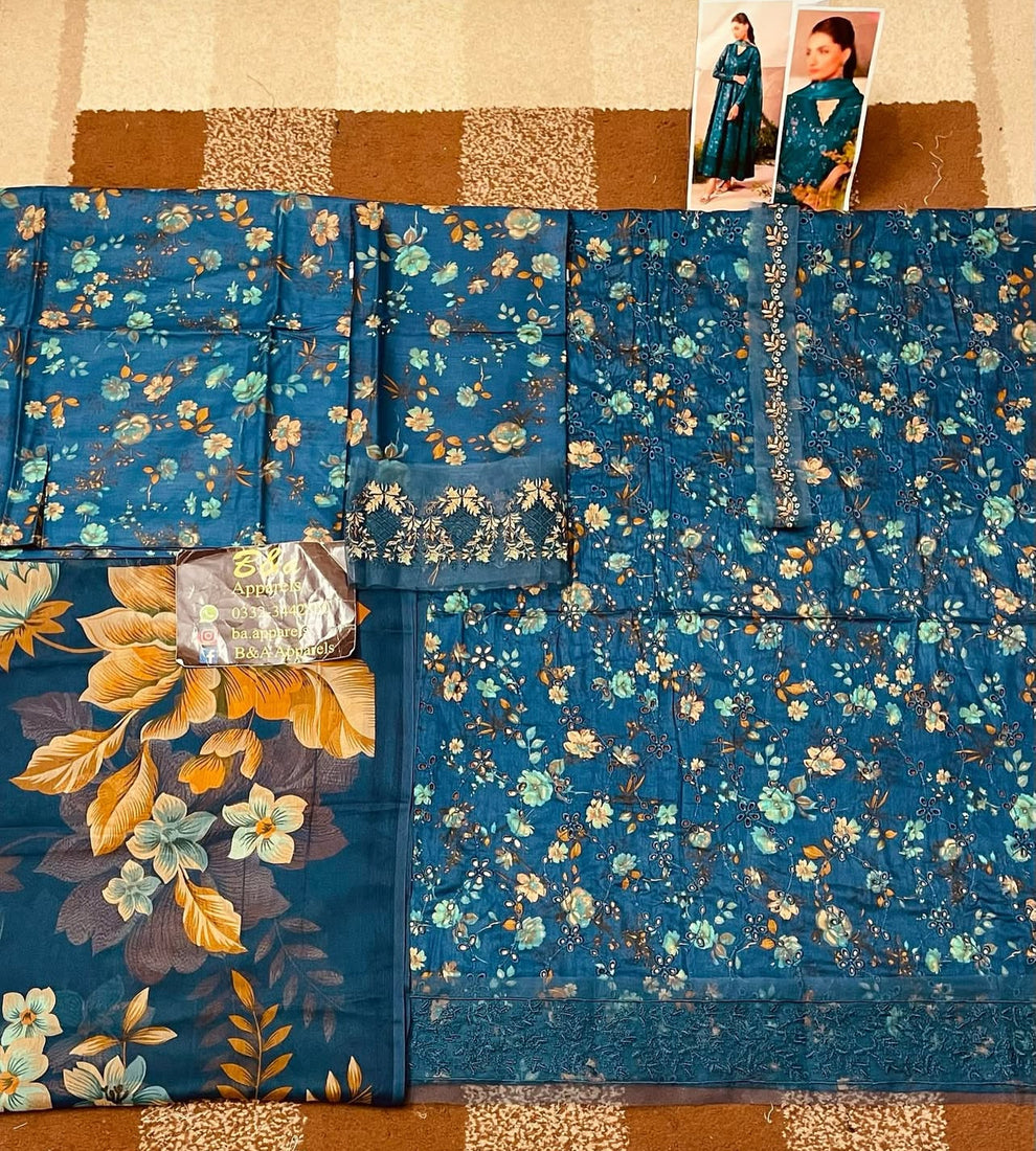 IZnik Zinc Printed Lawn 2025 unstitched 3-piece suit with embroidered lawn front, printed lawn dupatta with lace, and printed cotton trouser.